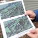 Dexter resident Barb Fike, on March 31, 2012, holds a Google Earth image of her property which was lined with tall pines (pictured to the left of the house in the lower image) before the tornado struck on March 15, 2012. Angela J. Cesere | AnnArbor.com
